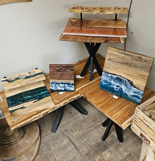 A display of cutting boards with various epoxy finishes.